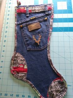 a pair of jeans that have been sewn together and are sitting on a cutting board