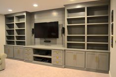 a large entertainment center with built - in shelving