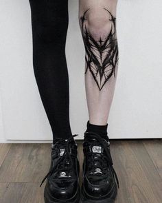 a woman's legs with tattoos on them