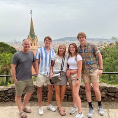 a group of people standing next to each other in front of a cityscape