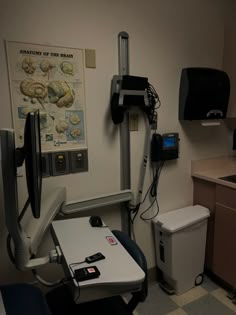 a hospital room with medical equipment on the wall, and a sink in the corner