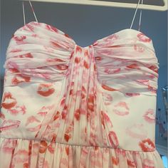 a dress hanging on a hanger with lipstick prints