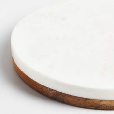 a close up of a white plate with wood trimmings on the edge and bottom