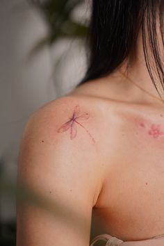 a woman with a tattoo on her shoulder