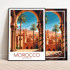 Experience the magic of Morocco on this artfully designed Morocco travel poster. The architecture of Morocco, characterized by warm red tones and artistic details, reflects the country's rich history and culture. The view through the gate captures the fascinating connection between city and nature, with the majestic desert reminiscent of the boundless expanse and the palm trees reminiscent of life-giving fertility. This Morocco poster brings the mystical beauty of Morocco straight to your home. Morocco Poster, City And Nature, Africa Vintage, Flat Decor, Artfully Designed, Morocco Travel, Multiple Images, Warm Red, Travel Collection