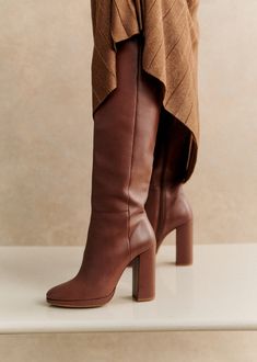 High heel thigh high boots;Made in our Portuguese atelier;Interior zip fastening system;Smooth leather exterior;Leather lining and insole;Leather and rubber outsole;Leather wrapped heel;Heel height: 11 cm / 4.3 in;Platform height: 1 cm / 0,4 in;Tone-on-tone metal zip Brown Knee High Boots, Wrap Heels, Boots Knee, Brown Leather Boots, Rubber Heels, Thigh High Boots, Tall Boots, Leather Wraps, Winter Style