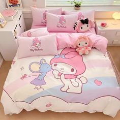 a hello kitty bed set with pink sheets and pillows