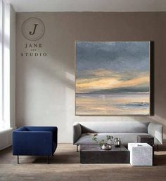 a living room with two couches and a painting on the wall above it that says jane studio