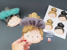 two handmade dolls with different hair styles are shown in front of a card and sticker