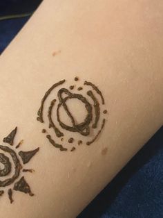 a person with a tattoo on their arm that has circles and stars drawn on it