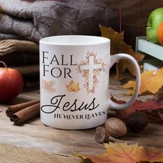 a coffee mug with the words, fall for jesus he never leaves