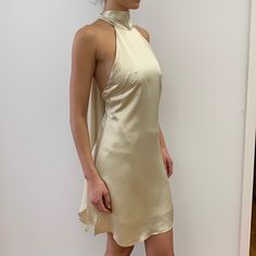 Backless, Tie Back Halter Dress. Fabric Is 100% Satin Cupro. Color Is An Off White, “Champagne” Color. Model Is 5’ 91/2” Tall. Dress Length Is 33 1/2” From Halter Neck Seam To Hem At Center Front. Side Zipper. Brand New Without Tags. Halter Top Dress Pattern, Elegant Champagne Mini Dress For Cocktail, Elegant Gold Cocktail Mini Dress, Champagne Sleeveless Mini Dress For Formal Occasions, Halter Tie Neck Dress, Formal Cream Satin Mini Dress, Elegant Champagne Mini Dress For Evening, Chic Gold Slip Dress For Evening, Champagne Mini Dress For Spring Date Night