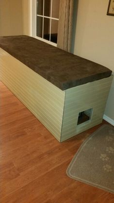 an empty room with a dog house on the floor