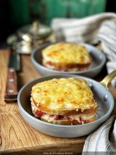 two pans filled with food sitting on top of a wooden table