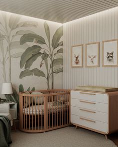 a baby's room with a crib, dresser and wallpapered walls