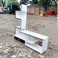 a white shelf sitting on top of a pile of rocks