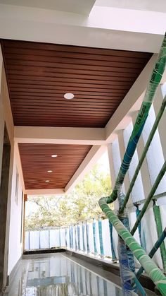 an indoor swimming pool with wood slats on the ceiling