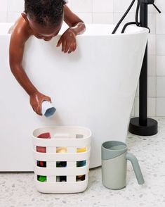 a man is cleaning his bathtub with a brush and soap dispenser