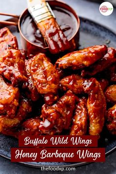 a plate filled with wings covered in bbq sauce