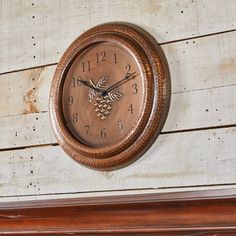 a clock mounted to the side of a wooden wall