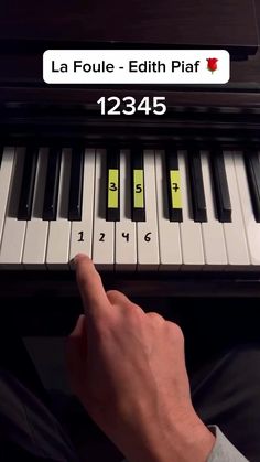 a person is playing the piano with their thumb on it's finger and fingers are pointing