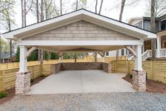 a covered parking lot in front of a house