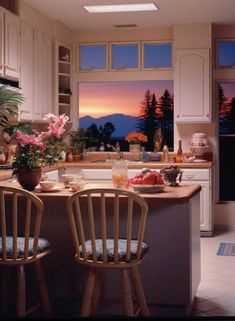 a kitchen with two chairs and a table in front of a window that has flowers on it