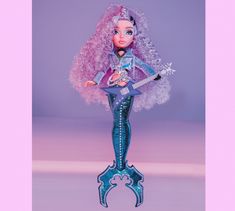 a barbie doll with pink hair holding a guitar and wearing a purple outfit that has snowflakes on it