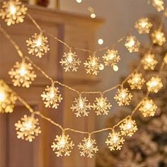 snowflake lights are hanging from a christmas tree