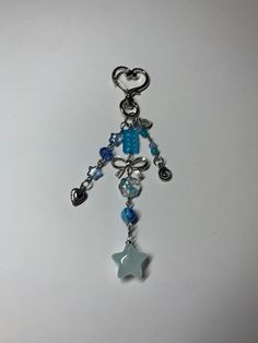 Handmade by me! FRAGILE: made with glass beads!! Perfect to hang on your car rear view mirror, purse, belt loop, journal, etc. Made with: an assortment of blue beads including flower, star, and swirl. Also made with a heart keychain clasp, stainless steel wire & jumprings, a swirly charm, heart charm, and the jelly star charm!  All orders come with extras!  && remember: the world is a better place with you in it! Mirror Purse, Keychain Blue, Star Keychain, Purse Belt, Fancy Accessories, Keychain Purse