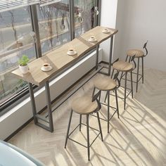 four stools and a table in front of a window