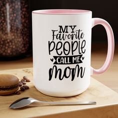 a pink and white coffee mug with the words my favorite people call me mom on it