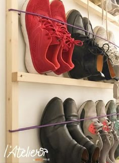 there are many pairs of shoes hanging on the wall