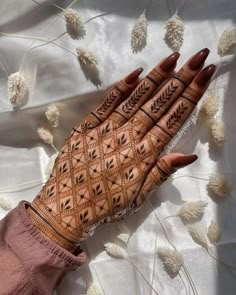 a woman's hand with henna on it