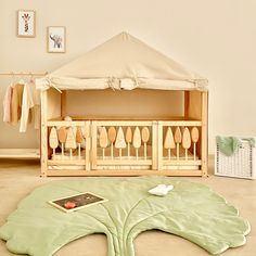 a baby crib in the middle of a room with an open canopy over it