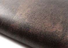 a close up view of a brown leather textured surface on a white tablecloth