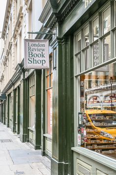 the london book shop sign is hanging on the store's glass front window,