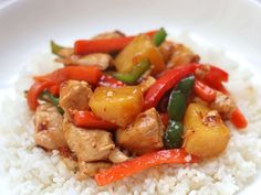 a white plate topped with rice and chicken