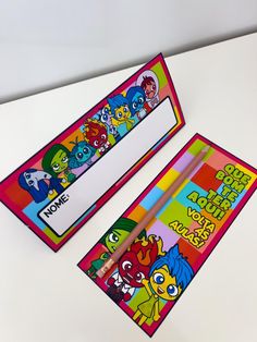 two children's pencils are sitting next to an eraser with cartoon characters on it