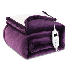 an electric blanket with a remote control on it