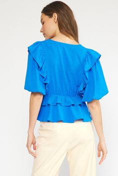 Spice up your wardrobe with this playful blue bubble sleeve peplum top! Featuring a V-neckline, ruffle tiers, and lightweight woven fabric, this top is both stylish and comfortable. Perfect to dress up or throw on with jeans or shorts. The non-sheer lining adds an extra layer of coverage, making it perfect for everyday wear. Don't miss out on this trendy addition to your closet! Shown with out Farrah Skirt Size and Fit: Emily is 5'1" and in a small, stock model is 5'9" and also in a small Spring V-neck Puff Sleeve Top With Ruffles, Spring V-neck Peplum Top With Ruffle Hem, Spring Chic V-neck Peplum Top, Chic V-neck Peplum Top With Ruffles, Trendy Flowy Top With Ruffle Sleeves, Trendy Flowy Tops With Ruffle Sleeves, Trendy Light Blue V-neck Blouse, Spring Peplum Blouse With Ruffles, Spring V-neck Blouse With Ruffle Hem