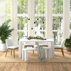 a white table and chairs in a room with large windows, potted plants on the far side