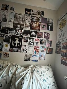 a bedroom with posters on the wall and a bed