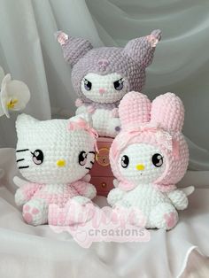 three crocheted stuffed animals sitting next to each other