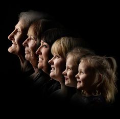 a group of older women standing next to each other in front of a black background