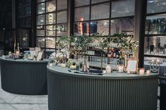 an outdoor bar with candles and flowers on it