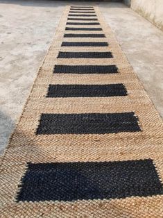 a black and tan striped rug on the ground