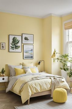 a bedroom with yellow walls and pictures on the wall