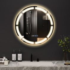 a bathroom with a sink, mirror and soap dispenser