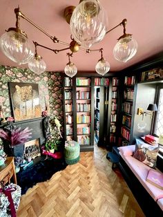 a living room filled with lots of furniture and bookshelves next to a fire place